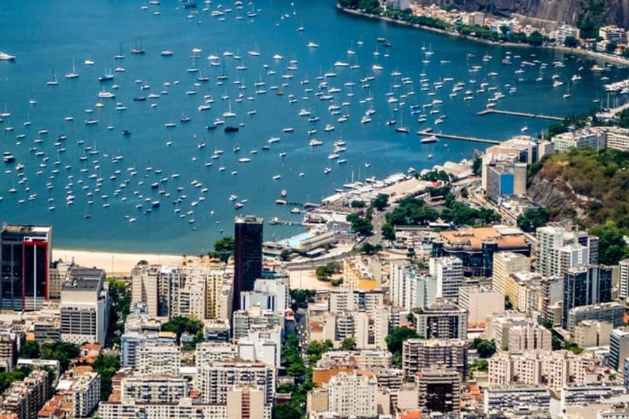 Boats moored in Botafogo Bay below the hills of Rio de Janeiro, Brazil