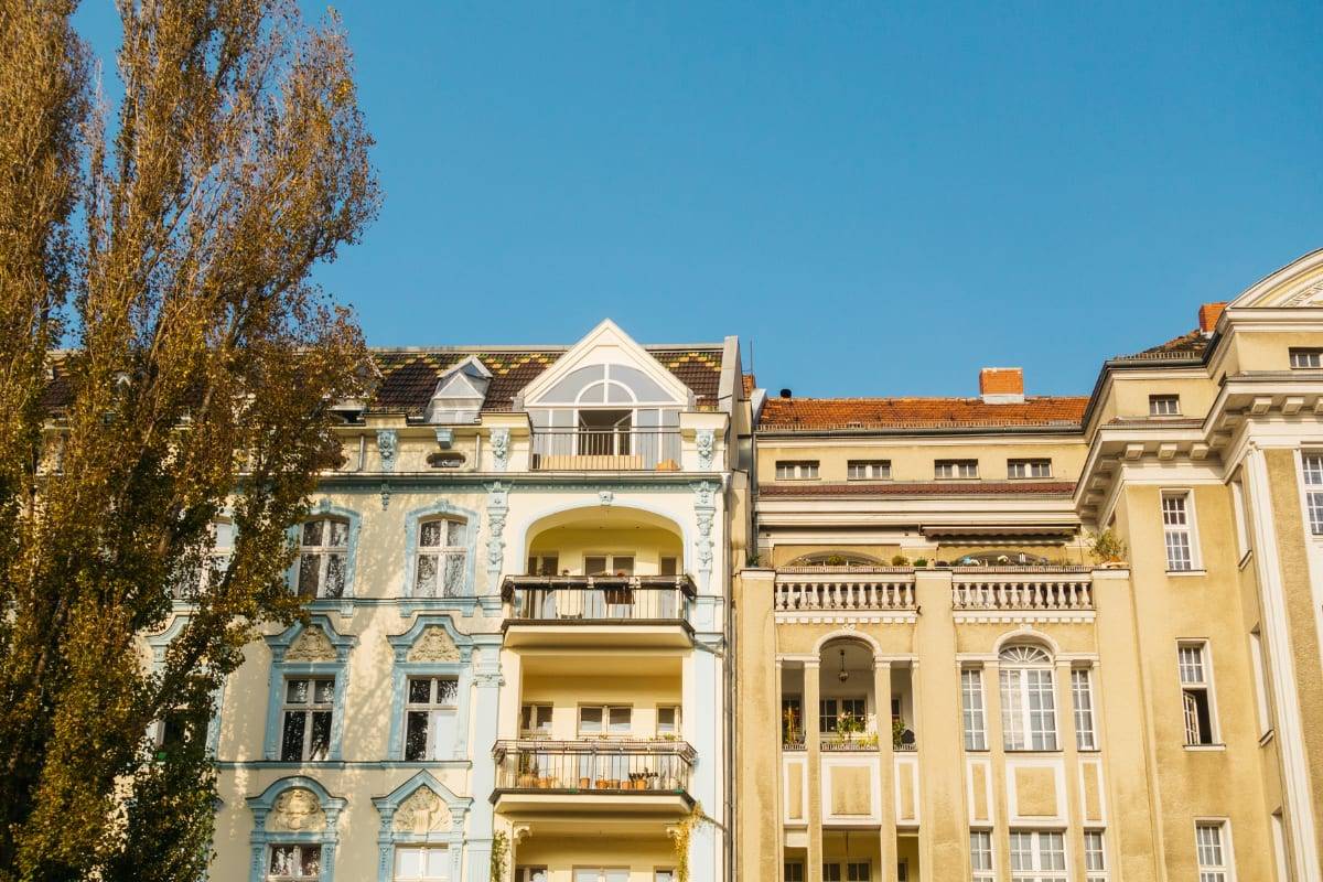 The ornate facades and balconies of old apartment buildings against a clear blue sky
