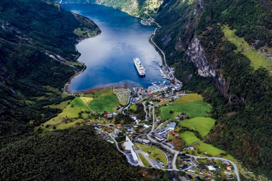 An aerial view of the village and cruise ship at the head of Geirangerfjord, Norway