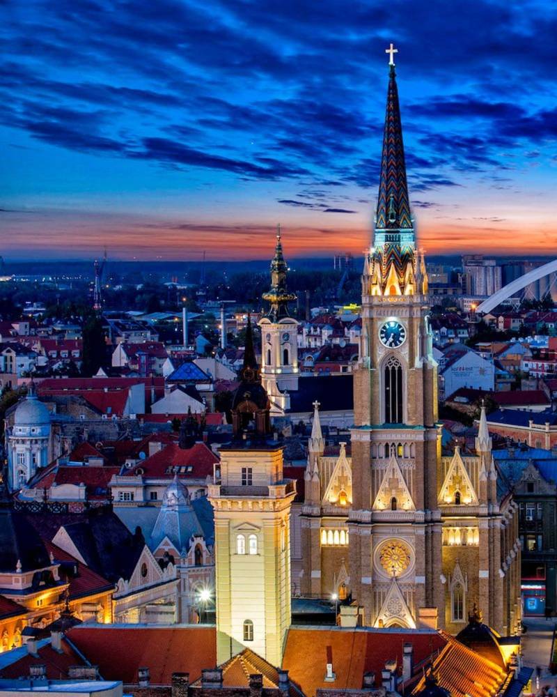 The Name of Mary Church spire above the old town rooftops at twilight, Novi Sad, Serbia